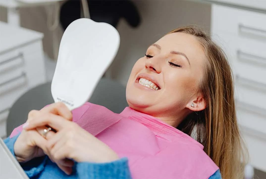 Woman smiling confidently after cosmetic dentistry
