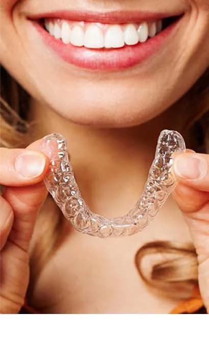 Dentist hands showing a dental orthodontic aligner appliance